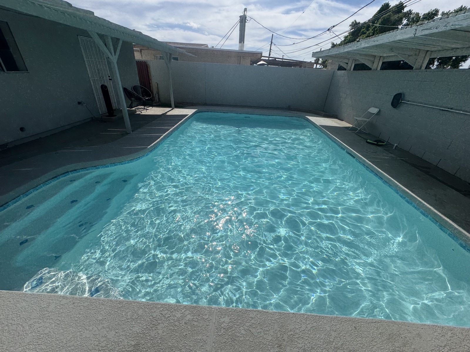 Same backyard pool clear and sparkling after a green-to-clean service by Legacy Pool Co.